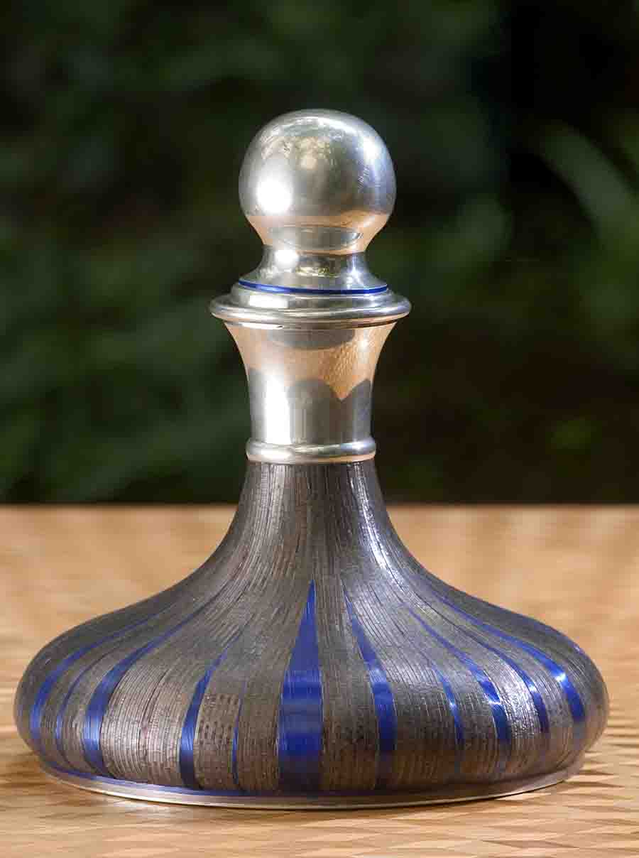 Old pewter decanter and straw marquetry